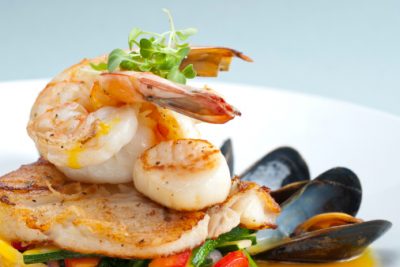 "Seafood medley of shrimp, scallops, mussels and fresh fish over a bed of vegetables."